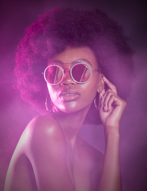 a beautiful African woman wearing Carrera sunglasses